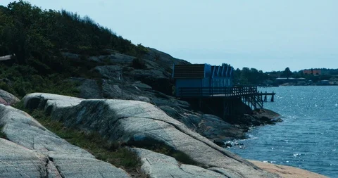 A seagull flies over the cliffs in the Swedish archipelago 스톡 동영상 113950698