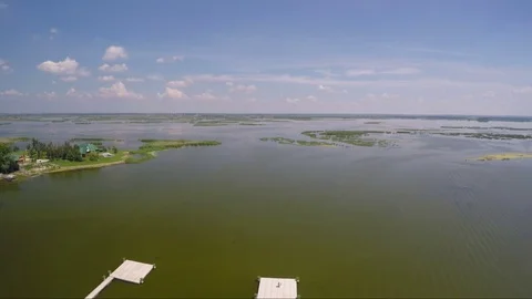 Seagull flies over the river with a pontoon Stock Footage 70852881