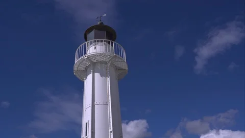 Seagull fly around a lighthouse in the background moving white clouds Stock-Footage 87999086