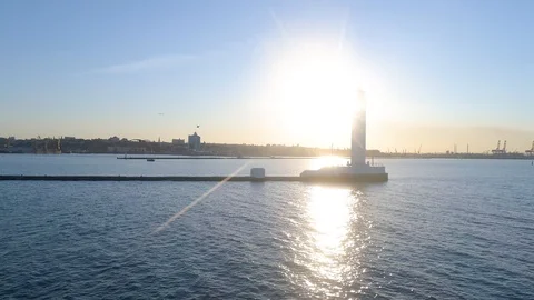 Seagull flying behind the drone. On the background of the city lighthouse and Stock Footage 121834090