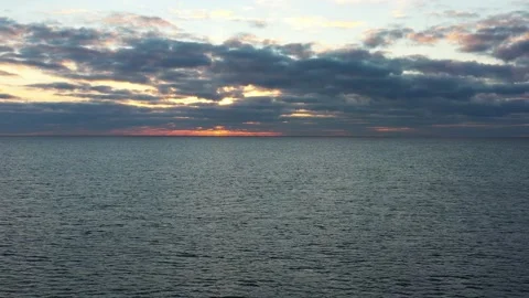Seagull flying over sea at background of cloudy sunset sky Stock Footage 164520422
