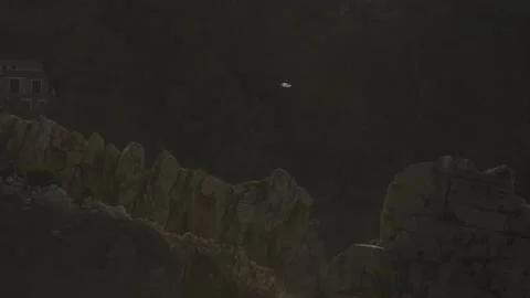 Seagull gracefully flying over large rocks in rough sea Video stock 168776703