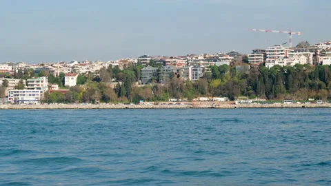 Seagulls fly as a ship passes through the city Stock Footage 260941599