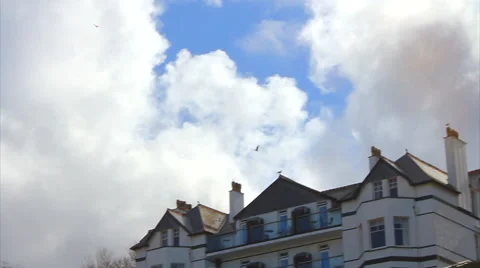 Seagulls Flying Over Hotel, Blue Sky and Clouds Slow-motion Stock Footage