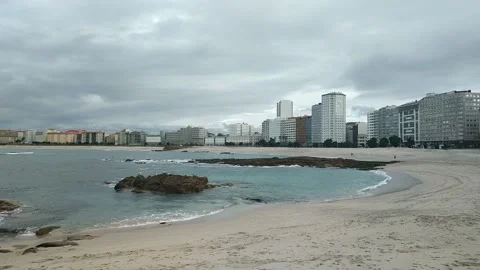 Seagulls perched on rocks at Riazor beach in A Coruna Stock Footage 148054685