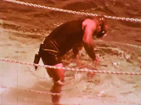 SEALAB II, an underwater habitat, develops a leak as it is lowered to the Stock Footage 75411471