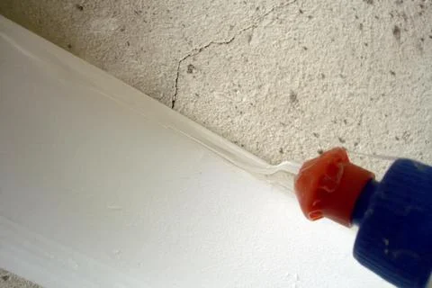 Sealing the Gap Between Baseboard and Wall for a Perfect Finish Stock Photos