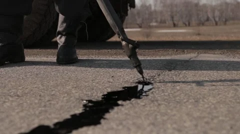 Sealing joint - crack in asphalt Stock Footage 56135909