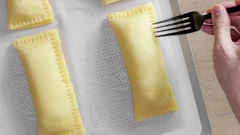 Sealing the seams of a pie using a fork Stock Footage 165126050