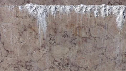 From the seam between the slabs of marble installed on the wall, salts of cement Stock Photos