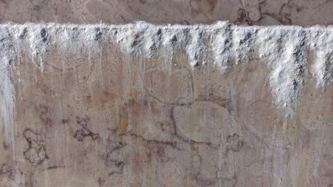 From the seam between the slabs of marble installed on the wall, salts of cement Stock Photos
