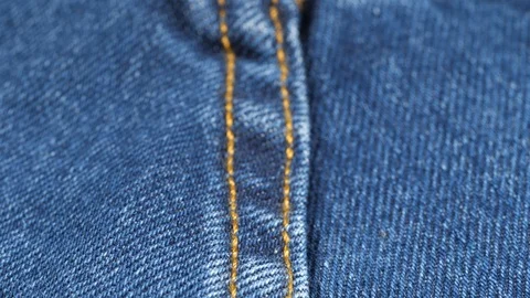 Seam on denim jeans, low angle. Shallow DOF. Close up, macro. Slider shot Video stock 121375528