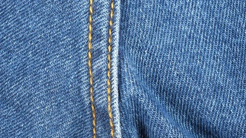 Seam on denim jeans, tracking macro. Denim textile. Top view. Slider shot Stock-Footage 121342995