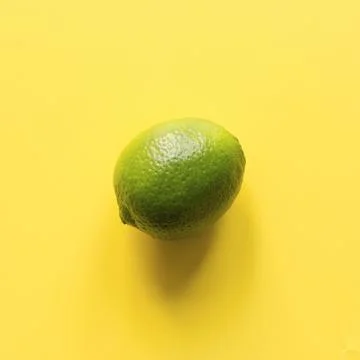 Seamleas limes pattern on yellow background. Stock Photos