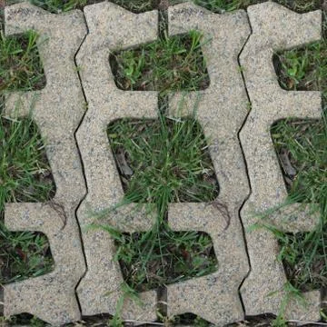 Seamles pattern of concrete road tile on the green grass path Stock Photos