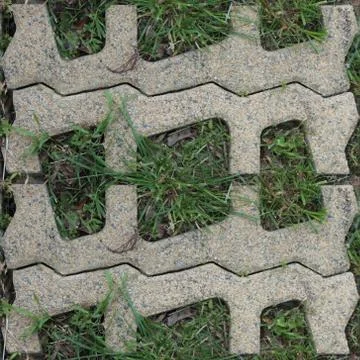 Seamles pattern of concrete road tile on the green grass path Stock Photos