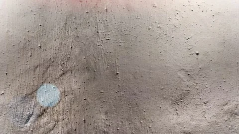 Seamless 4K looping vertical movement across a beige plaster wall with soft Stock Footage 344118988