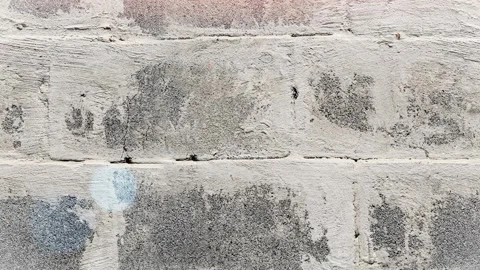 Seamless 4K looping vertical movement across a weathered gray brick wall with Stock Footage 344119248