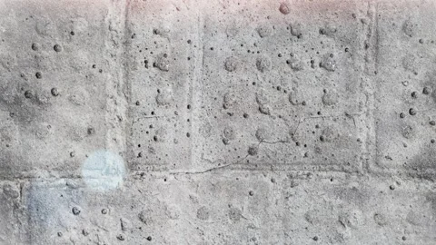 Seamless 4K looping vertical movement over a stained concrete wall with subtle Vídeos de archivo 344120555
