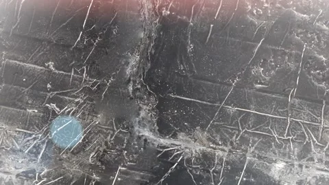 Seamless 4K looping vertical movement over a scratched dark metallic surface Stock Footage 344120993