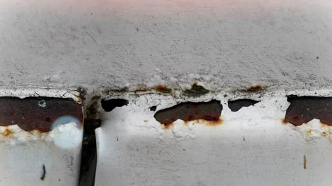 Seamless 4K looping vertical movement over a painted metal surface with rusted 動画素材 344124419