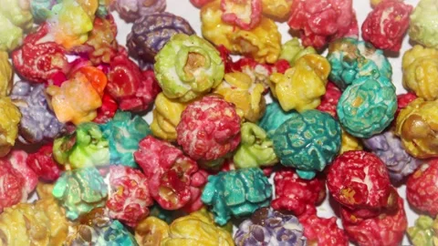 Seamless 4K looping vertical movement across colorful caramel popcorn with Stock Footage 344124991