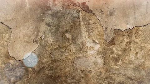 Seamless 4K looping vertical movement across an aged plaster wall with peeling 動画素材 344125173