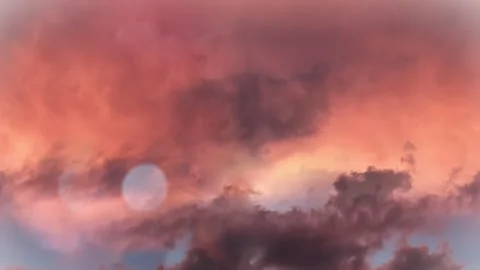 Seamless 4K looping vertical movement through glowing sunset clouds with vivid Vídeo Stock 344125321