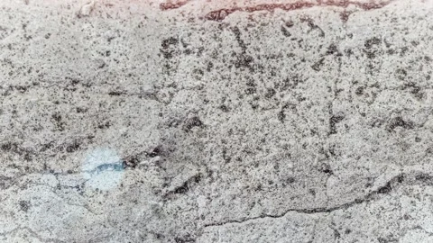 Seamless 4K looping vertical movement across a rough light concrete texture with Stock Footage 344125390