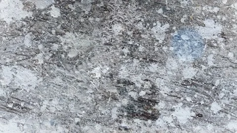 Seamless 4K looping vertical movement across a rough gray concrete texture with 스톡 동영상 344125595