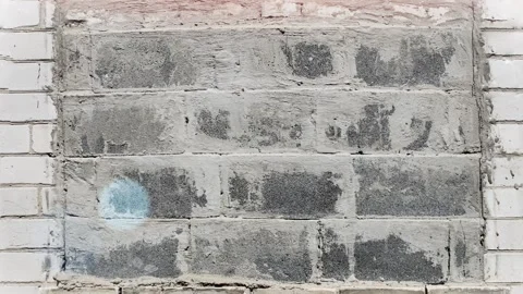 Seamless 4K looping vertical movement across an old brick wall with repaired Stock-Footage 344126932