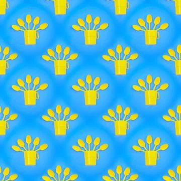 Seamless abstract background with yellow plastic cups and spoons on a blue ba Stock Photos