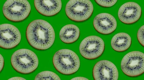 Seamless background with cut kiwi fruit on a green background Stock Photos