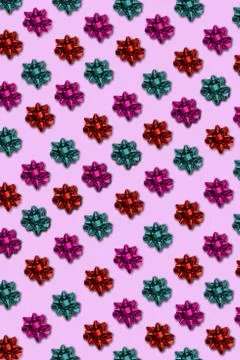 Seamless border stripe of colored packing bows on a pink background. Stock Photos