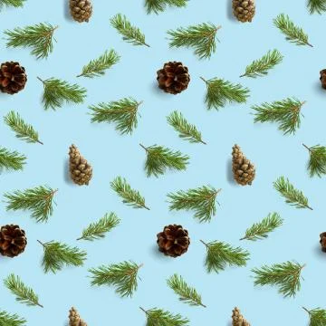 Seamless christmas pattern from Pine cones and pine twig on blue background.  Stock Photos