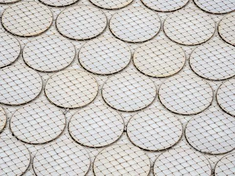 Seamless circular patterns behind a wire fence perfect for background Foto stock