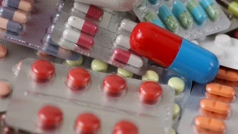 Seamless closeup loop of big pills among pile of blisters Stock Footage 123002296
