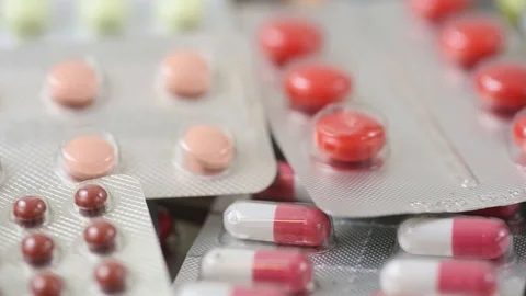 Seamless closeup loop of colorful medication in blisters Stock Footage 124636355
