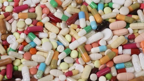 Seamless closeup loop of colorful pills in a pile rotating Stock Footage 123002319