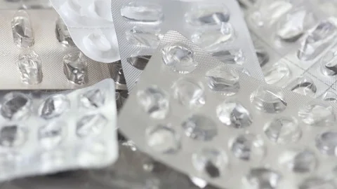 Seamless closeup loop of empty used pill blisters rotating Stock Footage 123479277