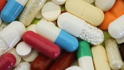 Seamless closeup loop of pills spinning through view Stock Footage 97053849