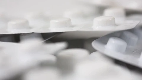 Seamless closeup loop shot of white pill blisters rotating Stock Footage 123002321