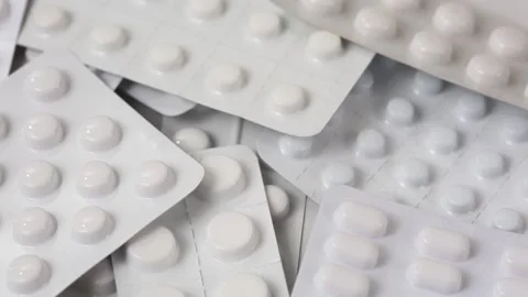 Seamless closeup loop shot of white blisters full of pills rotating Stock Footage 147200229