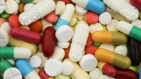 Seamless closeup loop of various pills spinning Stock Footage 95476710