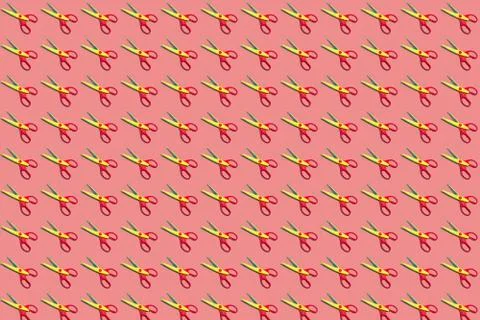 Seamless colorful pattern of open plastic yellow and red scissors on pastel p Stock Photos