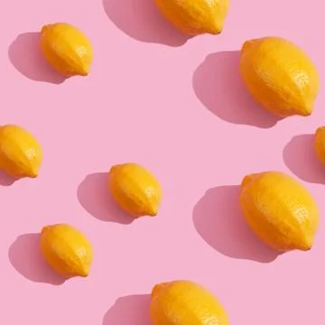 Seamless continuous pattern of yellow lemons on pink background. Minimalist c Stock Photos