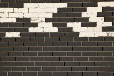 Seamless dark grey brick wall texture for background and architectural design Stock Photos