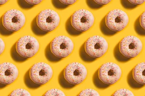 Seamless Doughnut Pattern on bright illuminating background Stock Photos