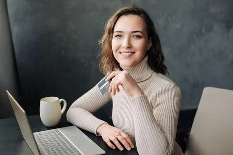Seamless E-commerce Experience. Young Woman Shopping Online with Credit Card and Stock Photos