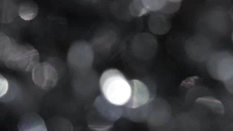 Seamless full-screen white bokeh lights flickering on a black background Stockbeeldmateriaal 317478836